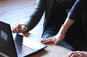 Image of people working over a laptop Image of people working over a laptop