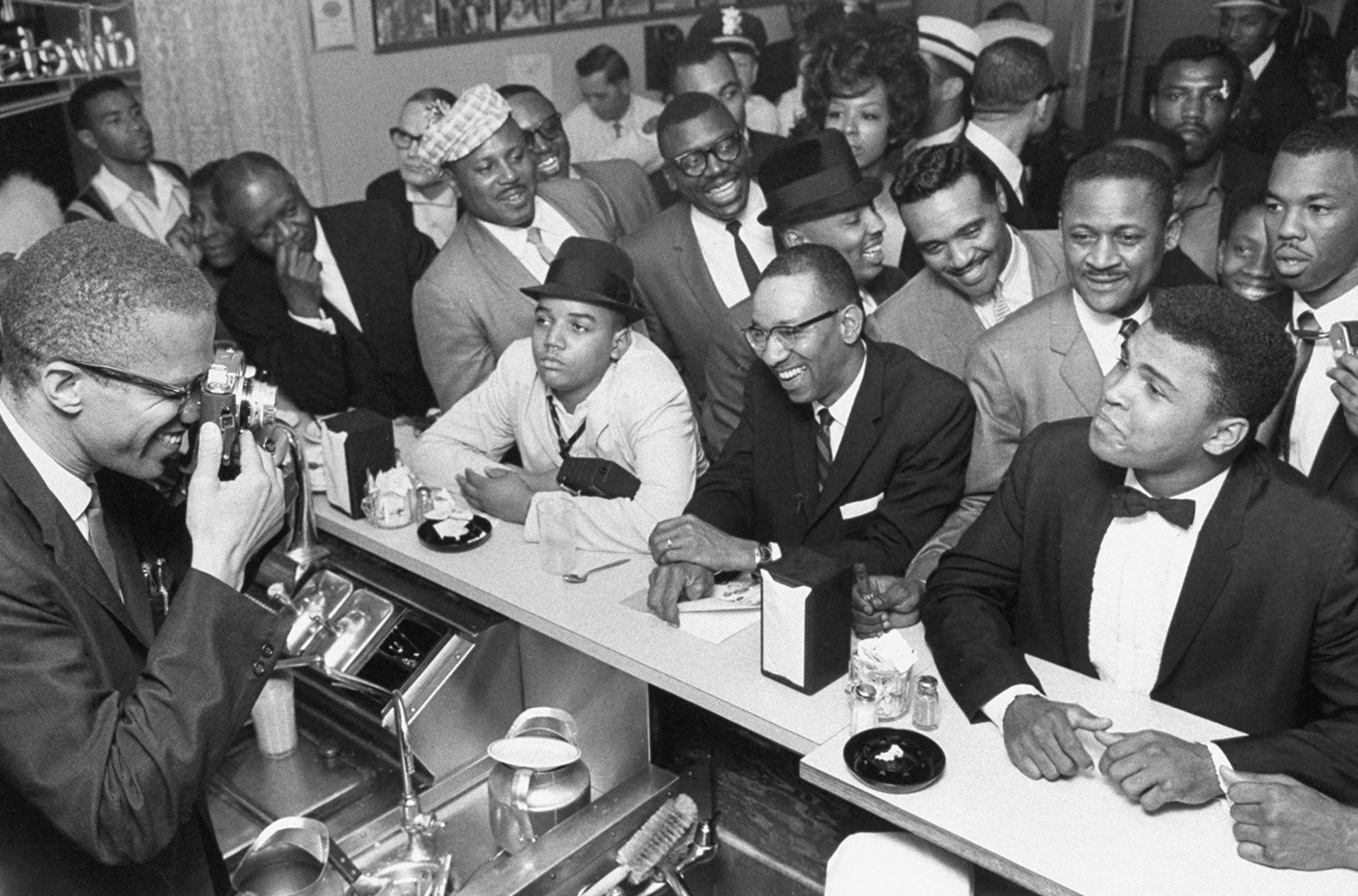 Malcolm X photographing Cassius Clay ©Bob Gomel: Muslim leader Malcolm X photographing Cassius Clay (soon to become Muhammad Ali) after he beat Sonny Liston for the Heavy Weight Championship, Miami, 1964