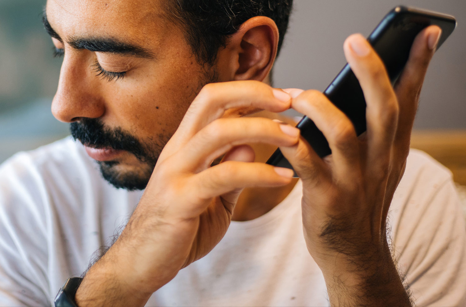 ADA Compliance Man holding a phone listening to a screen reader