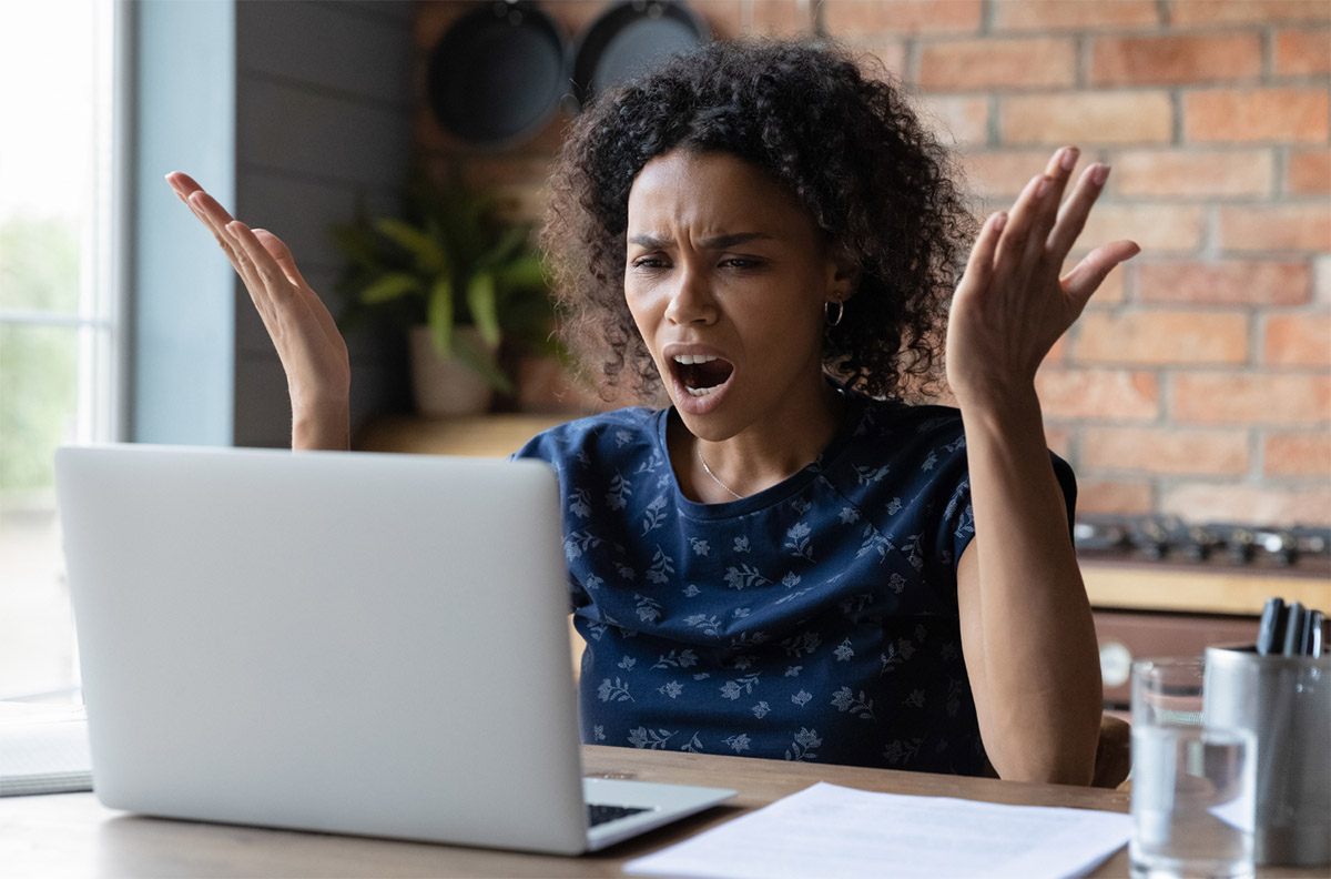 Office worker frustrated with laptop Office worker frustrated with laptop